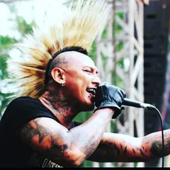 Roy Djihard performing on stage with a punk mohawk