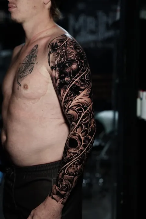 Realism Zeus god sleeve tattoo in black and grey, by Mr Ink Bali in Seminyak