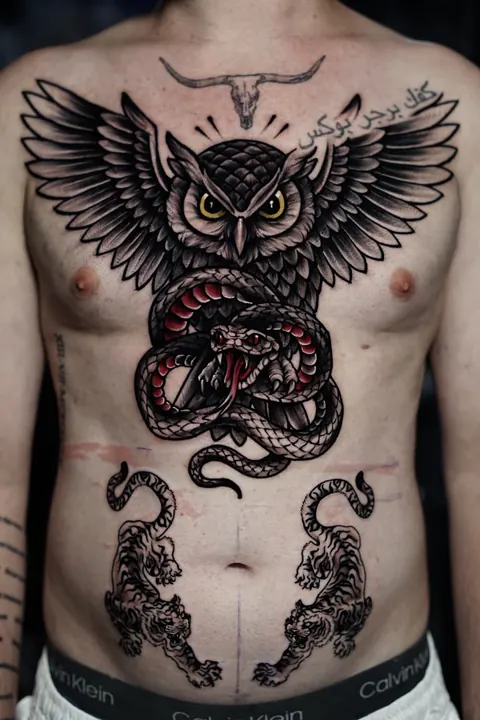 Traditional owl and snake chest and stomach tattoo with bold linework, done at Mr Ink Bali in Seminyak