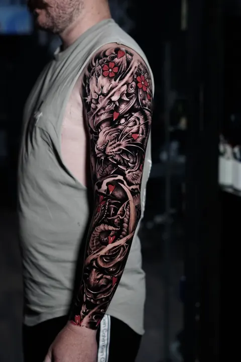 Japanese dragon and tiger sleeve tattoo with red accents, by Mr Ink Bali in Seminyak